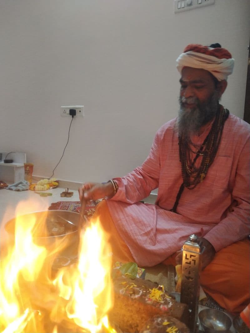 Flames rising from the havan kund as the Guru offers ghee