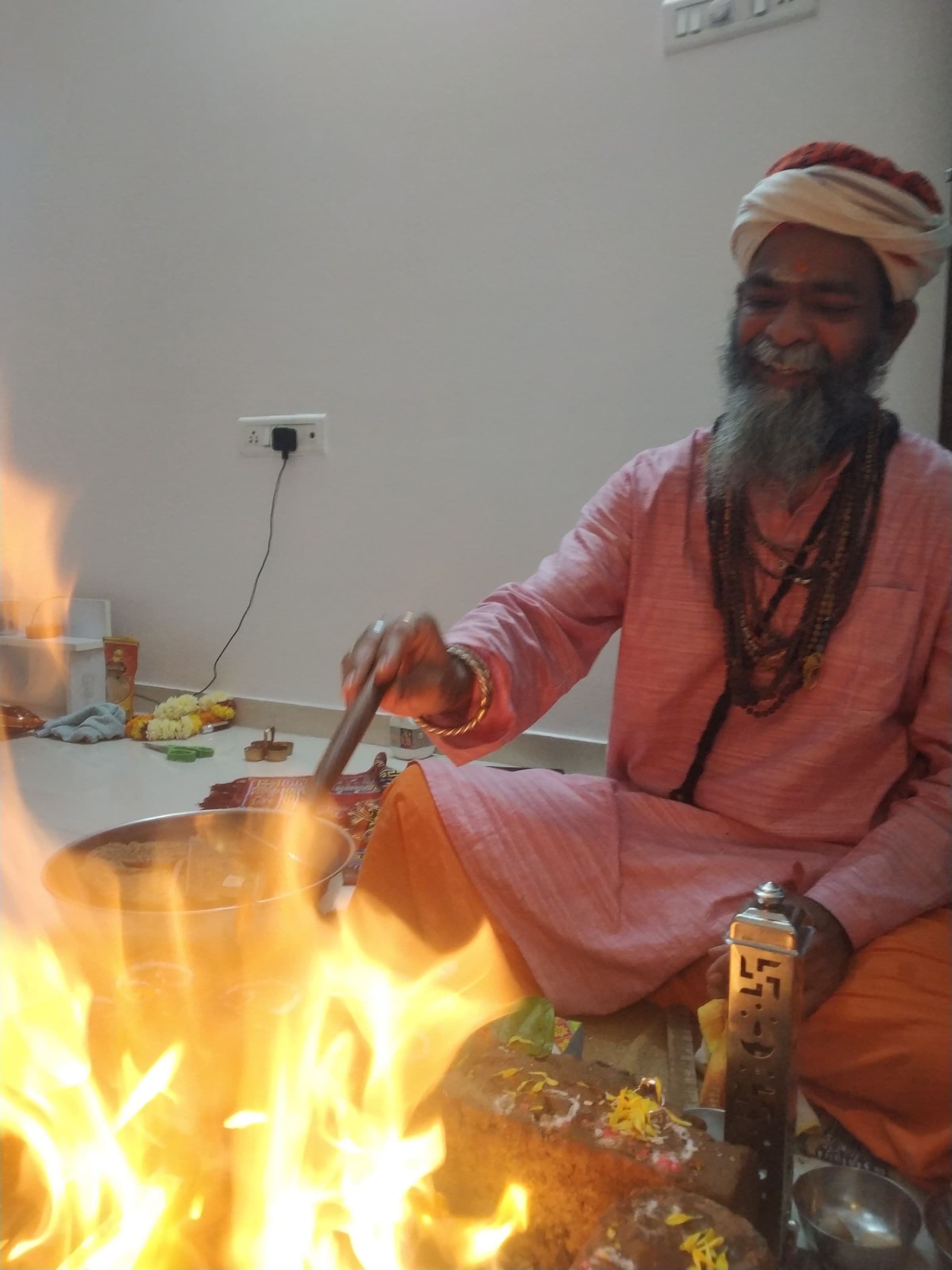 Guru Sanjay Nath making an offering into the havan fire