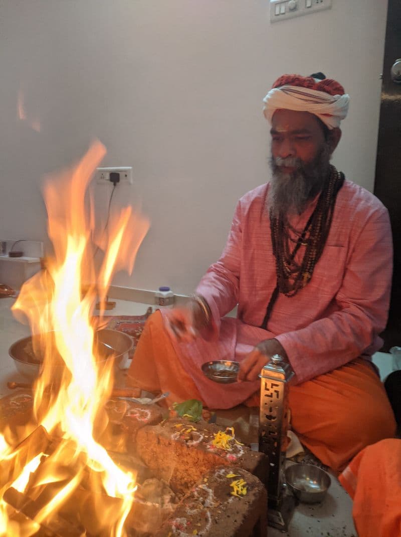 Havan in progress at the mandir, flowers and offerings arranged on the kund
